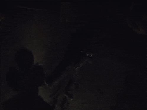 a man laying on the ground in the dark