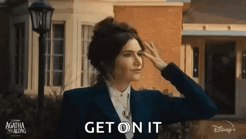 a woman in a suit and tie is saluting in front of a building .