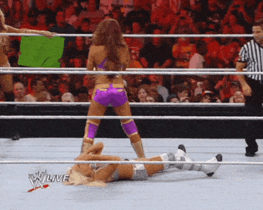 a woman in a wrestling ring holds a sign that says ' i love you '
