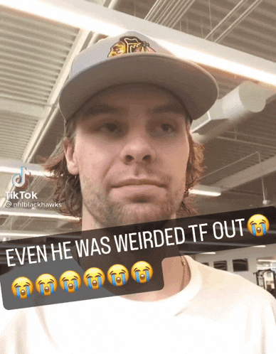a man wearing a hat and a white shirt has a sticker that says " even he was weirdered tf out "