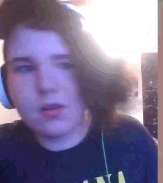 a close up of a person wearing headphones and a shirt that says n
