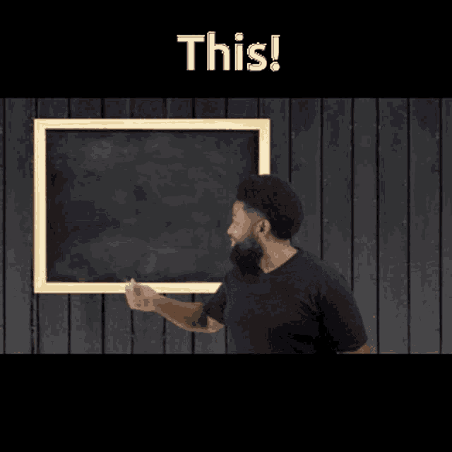 a man with a beard is standing in front of a blackboard that says this on it