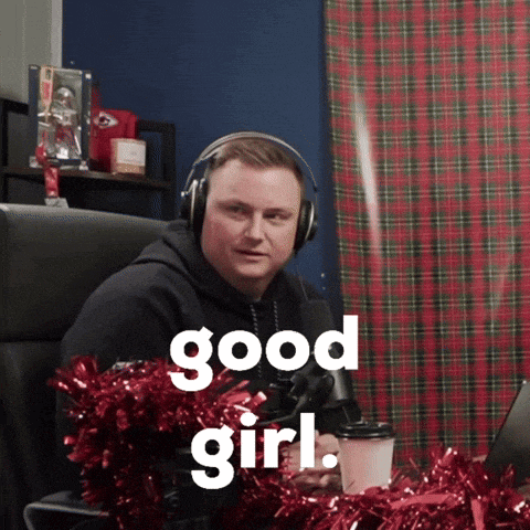 a man wearing headphones is sitting in front of a microphone and says good girl