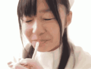 a close up of a girl drinking from a straw .