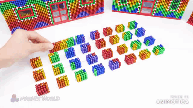 a person is playing with a bunch of magnets that are made in animatica