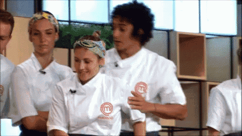 a group of people wearing white shirts with the letters m on them