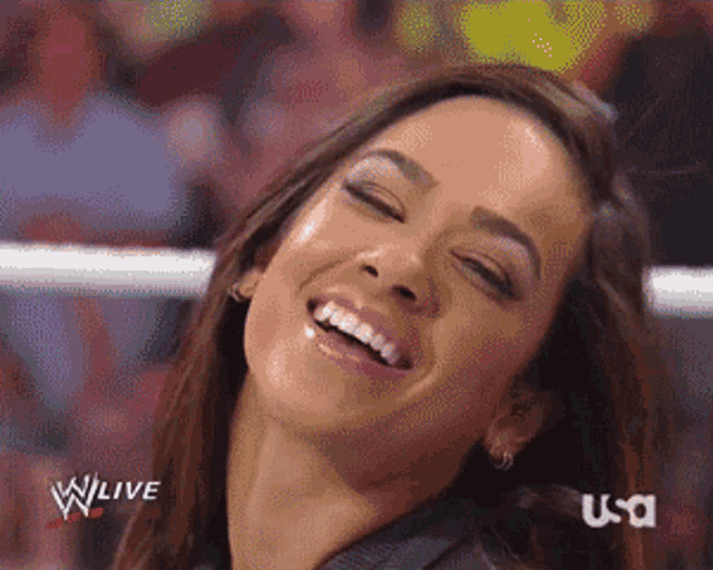 a woman is smiling in front of a screen that says wlive