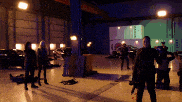 a group of people standing in a room with a sign that says argos