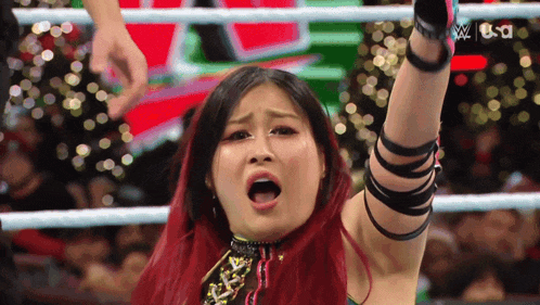 a woman in a wrestling ring with the word usd on the bottom right