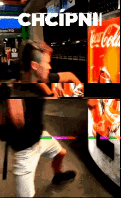 a man getting a drink from a vending machine that says coca cola