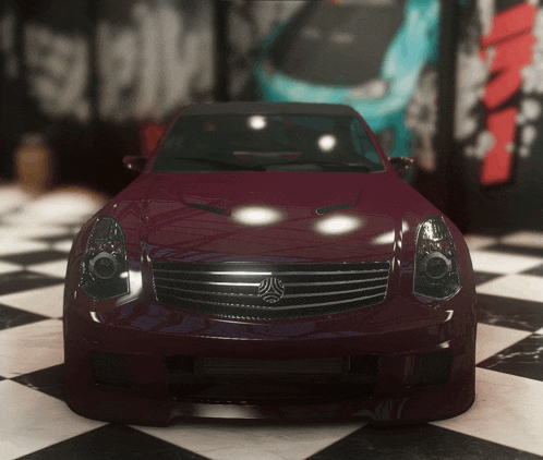 a red car is parked in a garage with graffiti on the wall behind it