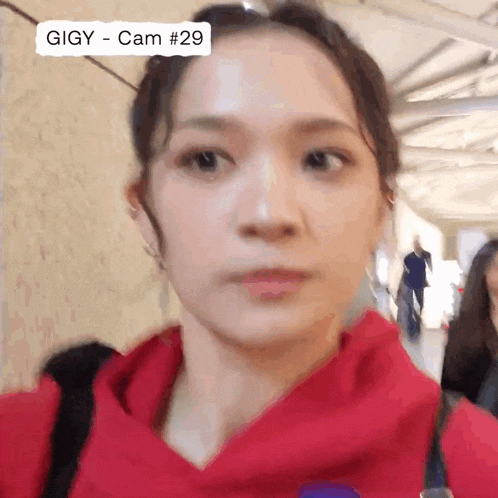 a close up of a woman 's face with the words gigy cam # 29 on the top