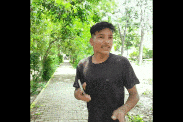 a young man wearing a black t-shirt with the letter a on it