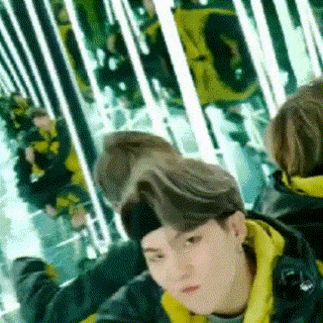a man wearing a headband is sitting in a room with a lot of mirrors .