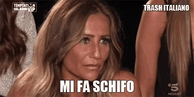 a woman with blonde hair is making a funny face and says mi fa schifo .