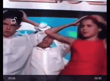 a woman in a red dress is dancing with a man in a white shirt behind her