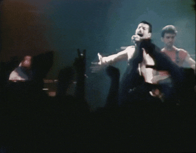 a man without a shirt is standing in front of a crowd of people