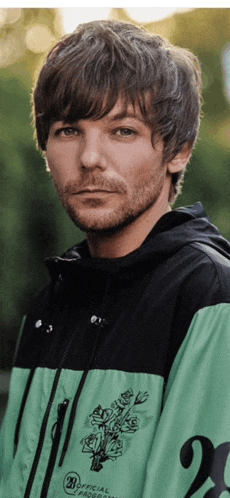 a man with a beard wearing a green and black jacket with the number 20 on the front