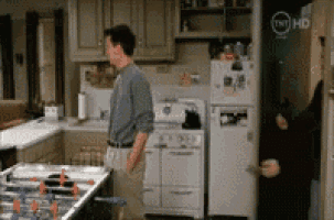 a man standing in a kitchen with tnt hd written on the corner