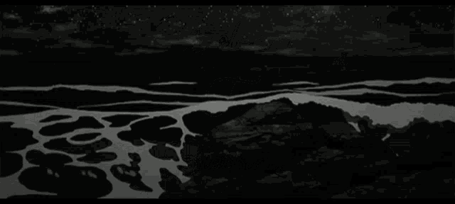 a black and white photo of a person 's face in the water with a reflection of a person in the water .