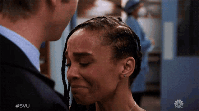 a man and a woman are looking at each other and the woman is crying ..