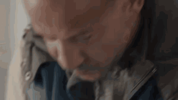 a close up of a man 's face with his eyes closed and his mouth open .