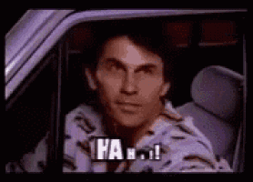 a man is sitting in a car and looking out the window .