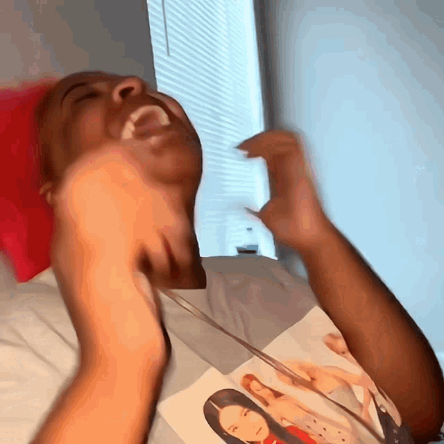 a man wearing a shirt with a picture of a woman on it is laughing