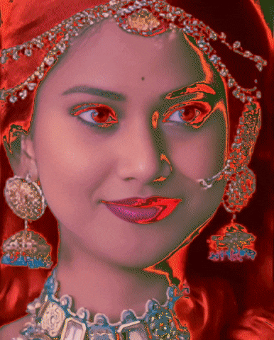 a close up of a woman 's face with earrings and a necklace