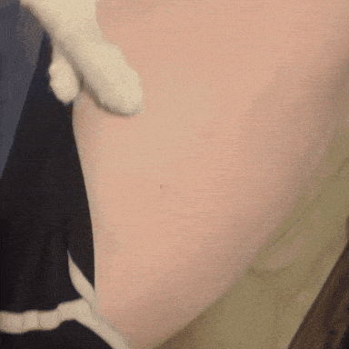 a close up of a cat 's paw on a pink item