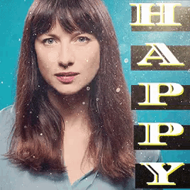 a woman is standing in front of a happy y sign