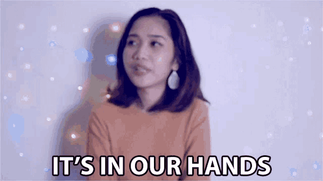 a woman says it 's in our hands in front of a white background