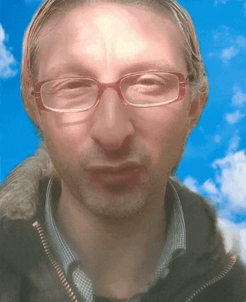 a close up of a man wearing glasses and a black jacket
