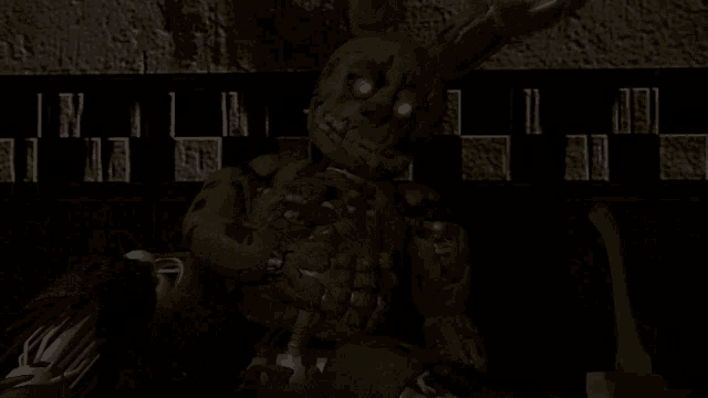 a video game character is laying on the floor in front of a checkerboard wall