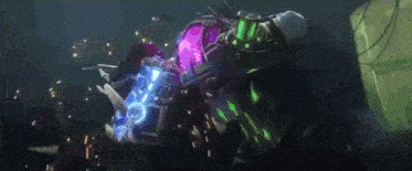 a person is holding a purple and blue object in their hand in a dark room .