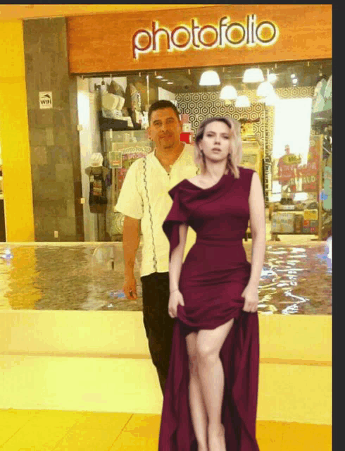 a photo of a man and a woman standing in front of a photofolio store