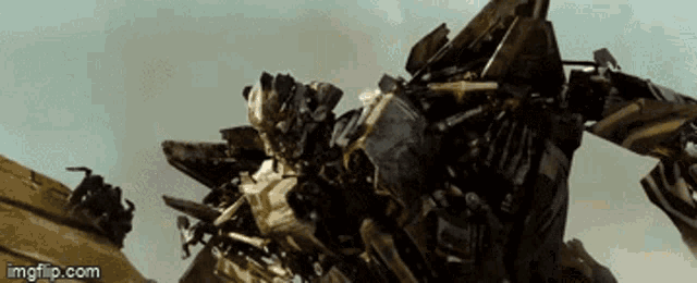 a transformer is flying through the air with a watermark that says imgflip.com on the bottom