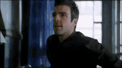 a man in a black shirt is standing in a room