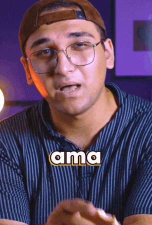 a man wearing glasses and a hat has the word ama written on his shirt