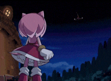 amy rose from sonic the hedgehog is standing in front of a building on fire