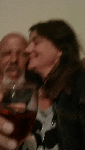 a man and a woman are toasting with wine glasses