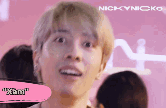 a close up of a man 's face with the name nickynicko on the bottom
