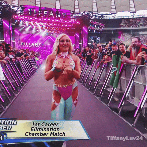a woman in a pink and blue outfit is walking down the aisle of a tiffany stadium