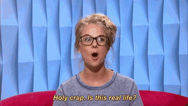 a woman with glasses says holy crap