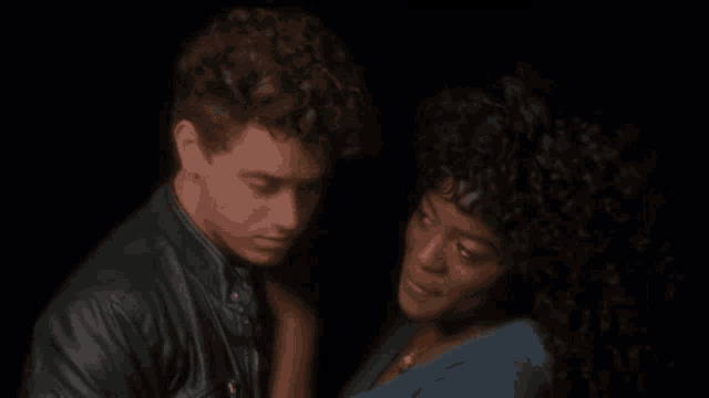 a man and a woman are standing next to each other