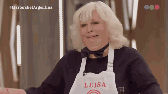 a woman wearing an apron that says luisa