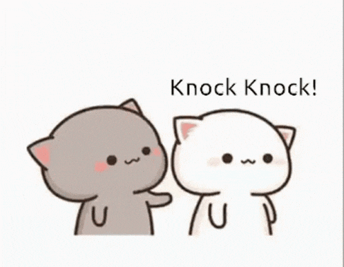a couple of cats are standing next to each other and one of them is touching the face of the other cat .