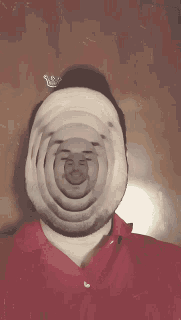 a man in a red shirt has many faces on his face including a bearded man