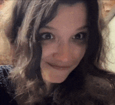 a close up of a woman 's face with a smile on her face .