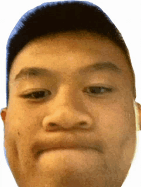 a close up of a young man 's face with a serious look on his face